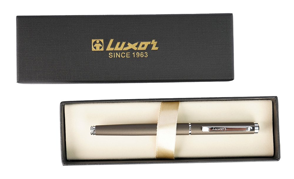 Подарочная перьевая ручка Luxor Rega представляет собой идеальное сочетание классического стиля и современного дизайна, что делает её превосходным выбором для офисного использования. Выполненная в черно-хромированном металлическом корпусе, эта ручка привлекает внимание своим респектабельным и роскошным внешним видом, который прекрасно подчеркнет вашу деловую индивидуальность.

Синий цвет чернил, обеспечиваемый высококачественным наконечником, создает четкие и выразительные линии, идеально подходящие для создания записей, подписания документов или ведения заметок. Благодаря продуманной конструкции ручка легко скользит по бумаге, что обеспечивает гладкое и комфортное письмо без усталости в руке, даже при длительном использовании.

Каждая ручка REGA поставляется в изящном подарочном футляре, что делает её отличным подарком для коллег, руководителей или клиентов. Это не просто предмет канцелярии, а стильный аксессуар, который станет надежным спутником в мире бизнеса и каждодневных деловых записей.
